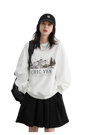 Woman wearing a white sweatshirt with text and graphics, black cap, and black skirt on a light gray background