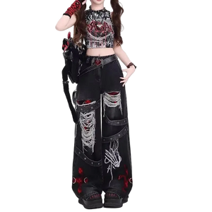 Person wearing a gothic-inspired outfit with black pants and crop top on a white background