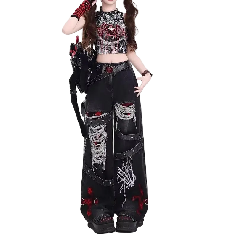 Person wearing a gothic-inspired outfit with black pants and crop top on a white background