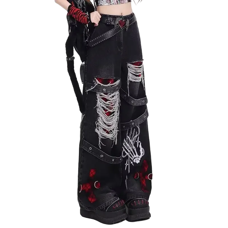 Black distressed jeans with decorative elements on a white background