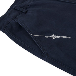 Navy blue pants with a white embroidered design on a white background
