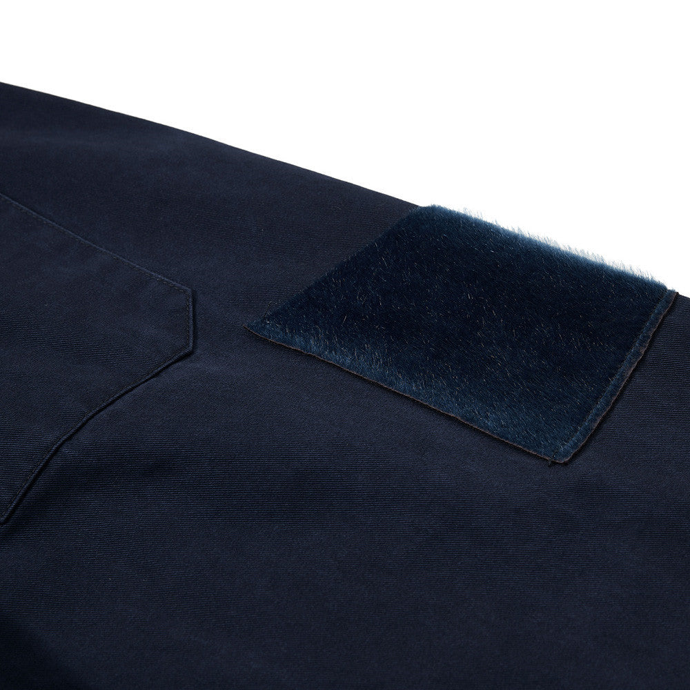 Navy blue fabric with a textured patch on a white background