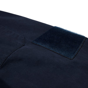 Navy blue fabric with a textured patch on a white background