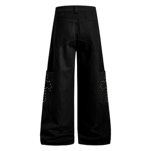 Black wide-leg pants with decorative cutouts on a white background