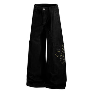 Black wide-leg pants with decorative embellishments on a white background