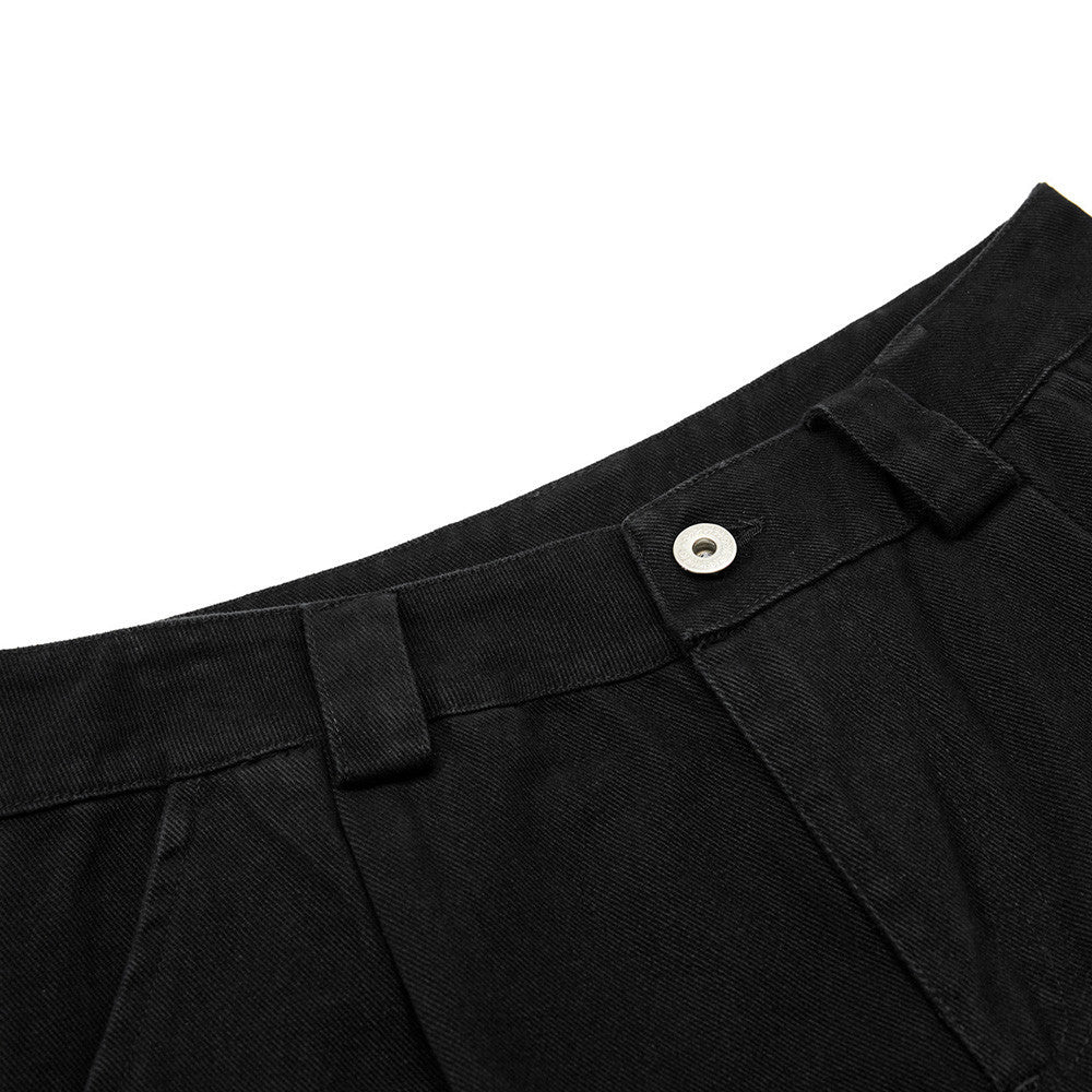 Close-up of black pants with a button on a white background