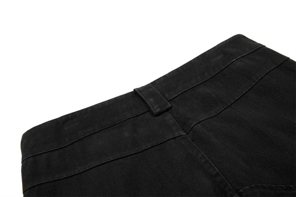 Close-up of a black fabric with a pocket detail on a white background