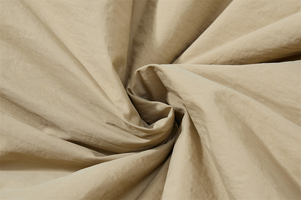 Close-up of beige fabric with folds