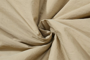 Close-up of beige fabric with folds