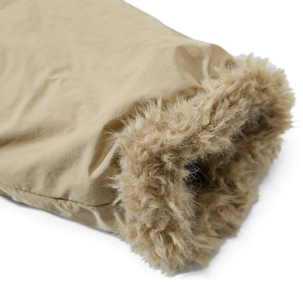 Beige blanket with fluffy trim on a white background
