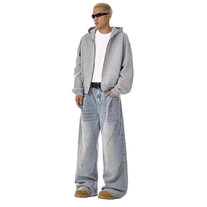 Person wearing a gray hoodie and light blue jeans on a white background