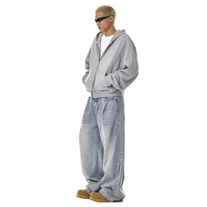 Person wearing a gray hoodie and light blue jeans on a white background