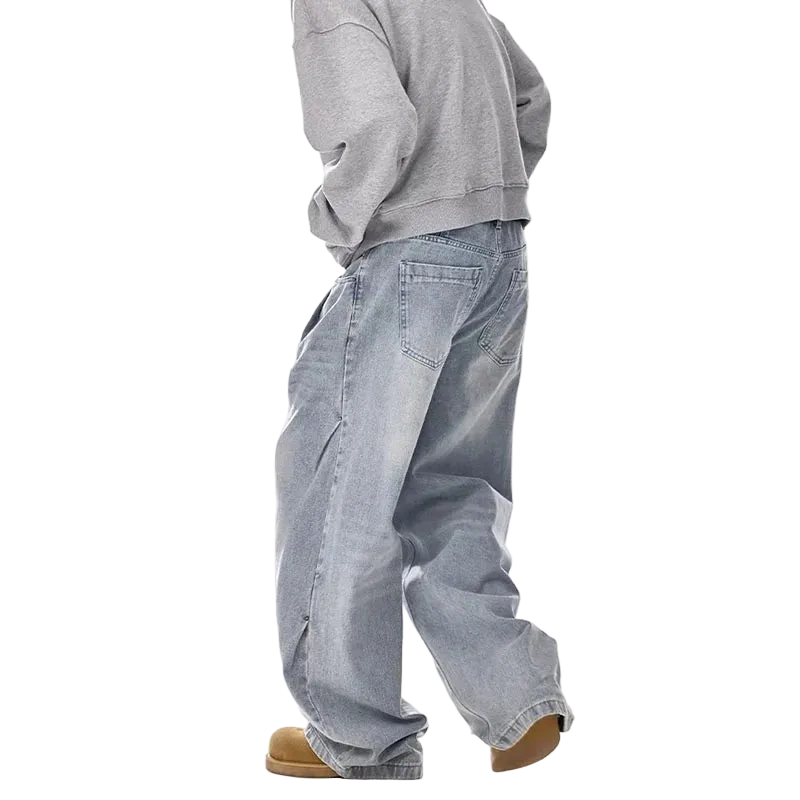 Person wearing a gray sweatshirt and light blue jeans on a white background
