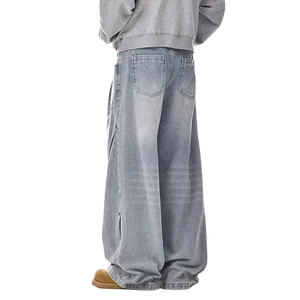 Person wearing light blue jeans and a gray sweatshirt on a white background
