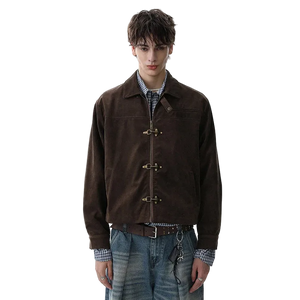 Person wearing a brown jacket with d-ring fastenings on a white background
