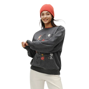 Person wearing a dark gray sweatshirt with colorful designs on a white background