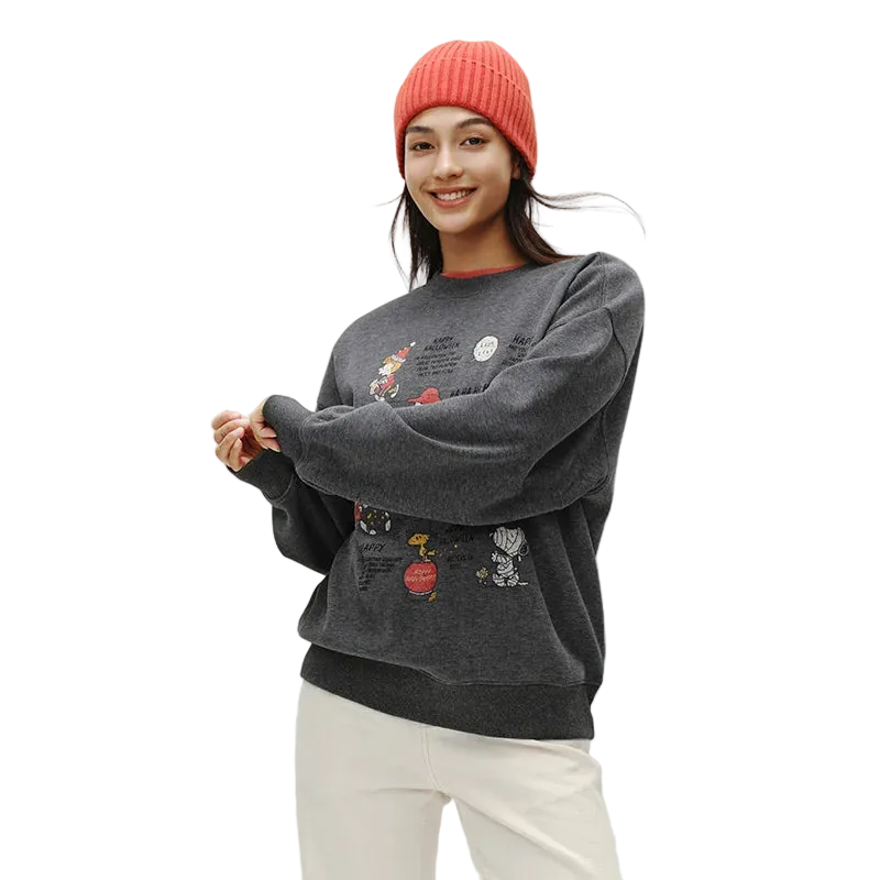 Person wearing a dark gray sweatshirt with colorful designs on a white background