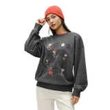 Person wearing a gray sweatshirt with cartoon character designs on a plain background