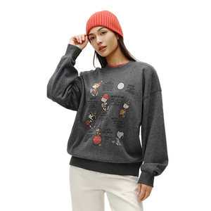 Person wearing a gray sweatshirt with cartoon character designs on a plain background