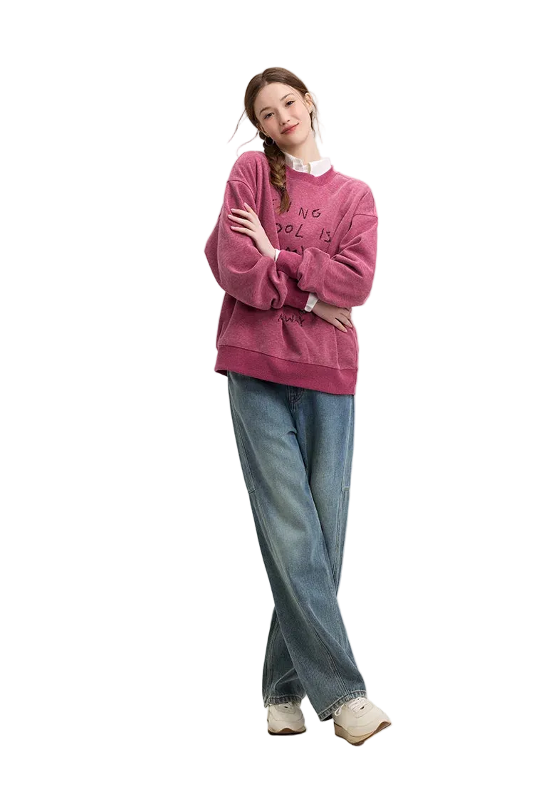Person wearing a pink sweatshirt and blue jeans on a white background