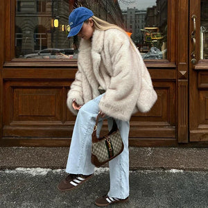 Rock this plush white faux fur jacket to bring a touch of luxury and cozy warmth to your everyday street style.