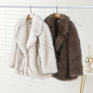Two fur coats, one white and one brown, hanging on a rack against a white background.