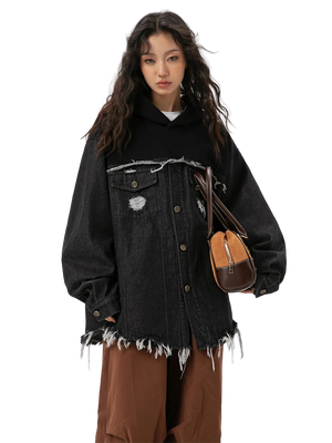 Person wearing a black distressed denim jacket with a white background