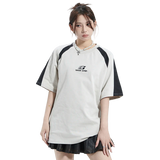 Person wearing a white and black sports outfit with a brand logo on a white background