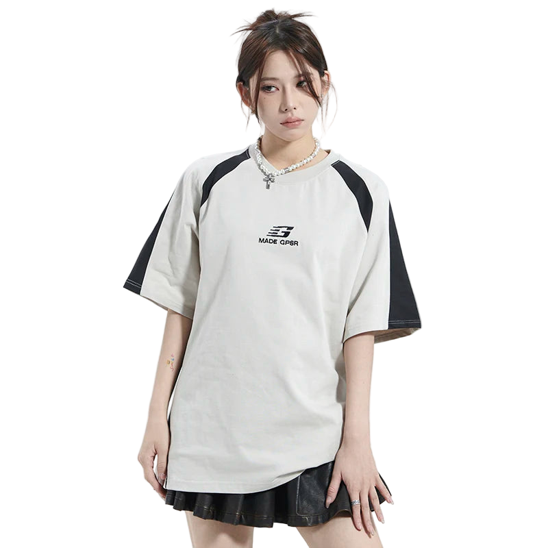 Person wearing a white and black sports outfit with a brand logo on a white background