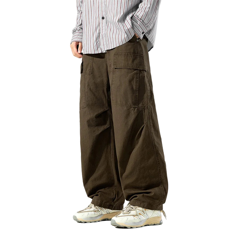 Person wearing brown cargo pants and a striped shirt on a white background