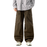 Person wearing brown cargo pants and a striped shirt on a white background