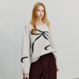 Pull femme jacquard à nœud papillon