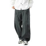 Person wearing gray cargo pants and a white shirt on a white background