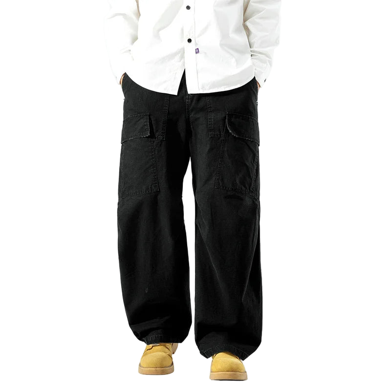 Person wearing black wide-leg pants and a white shirt on a white background