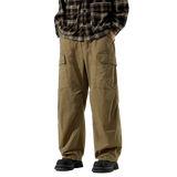 Person wearing brown cargo pants and a plaid shirt on a white background