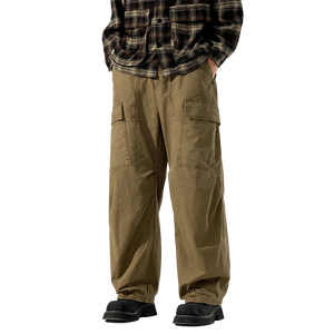 Person wearing brown cargo pants and a plaid shirt on a white background