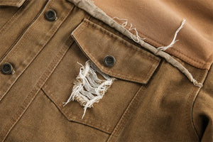 Close-up of a brown jacket with frayed edges and buttons.