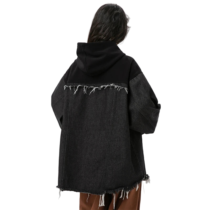 Person wearing a black distressed denim jacket on a white background