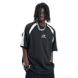 Person wearing a black and white sports jersey with a brand logo on a white background