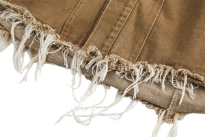 Close-up of brown denim fabric with frayed edges on a white background