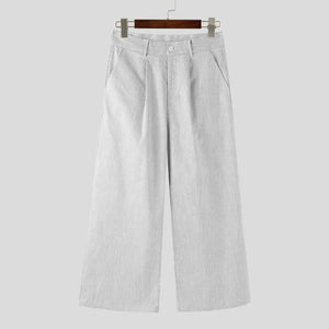 Light gray pants on a hanger against a white background