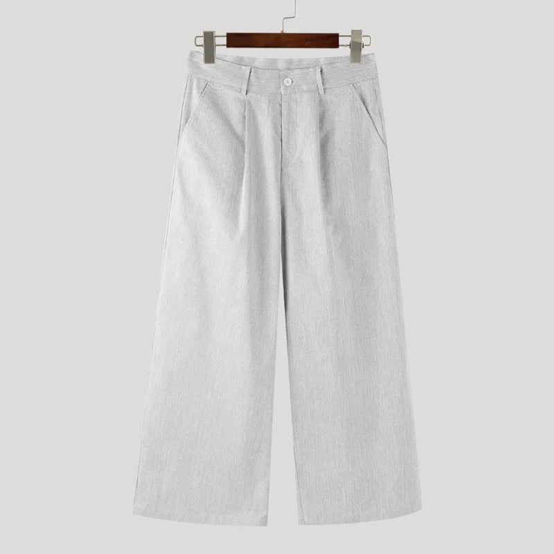 Light gray pants on a hanger against a white background