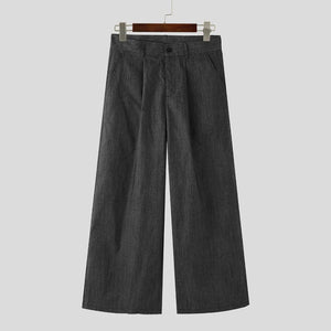 Dark gray wide-leg pants on a hanger against a light gray background