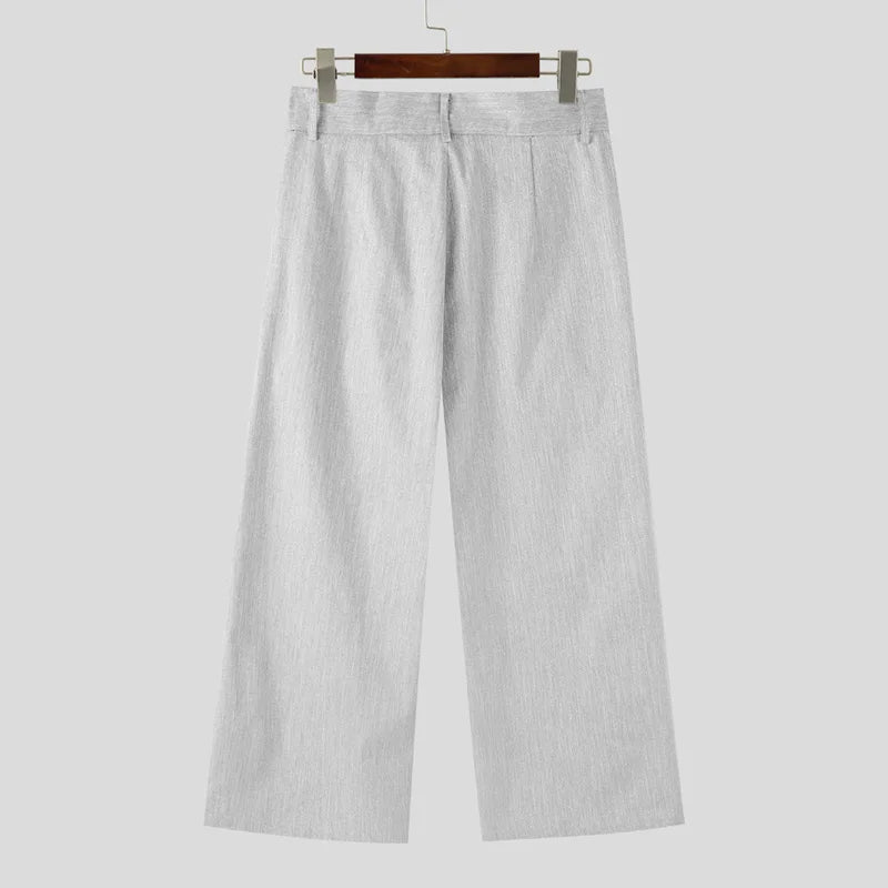Light gray pants on a hanger against a white background