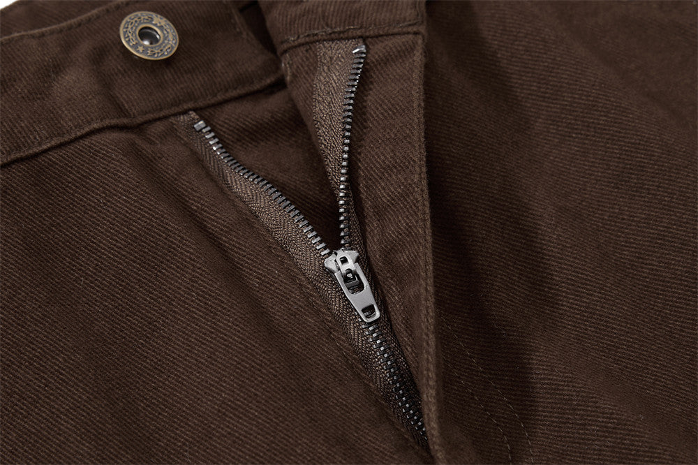 Close-up of brown pants with a zipper detail