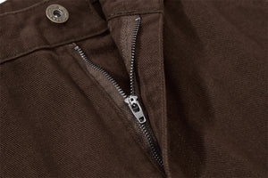 Close-up of brown pants with a zipper detail