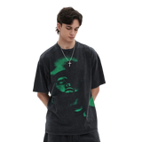 Person wearing a black t-shirt with a green graphic design on a white background