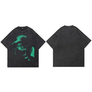Black t-shirt with green graphic design on a white background
