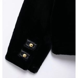 Close-up of a black coat with gold buttons on a white background
