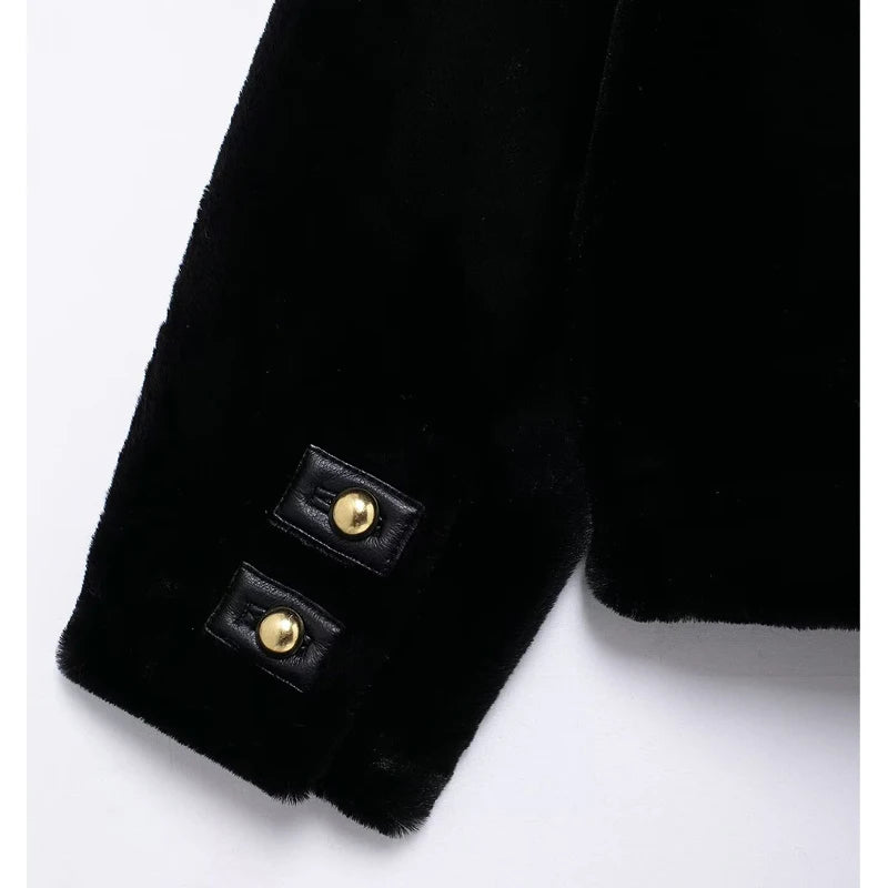 Close-up of a black coat with gold buttons on a white background